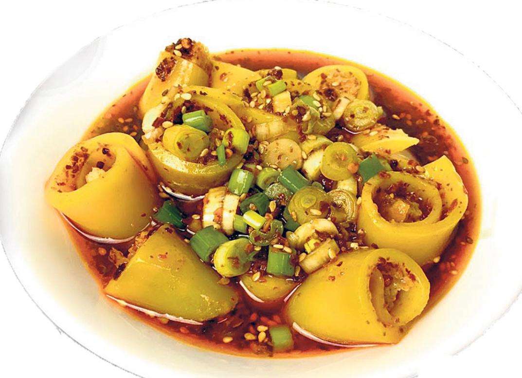 Freshly cooked Lhaping served on a white plate against a white background.