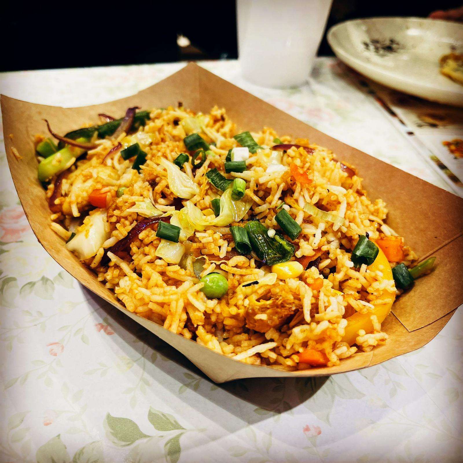 Chicken Fried Rice, served on a brown platter against a white table in the My Kitchen restaurant.