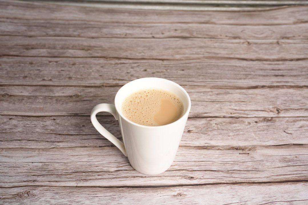 Masala Tea in a white mug against a wood background