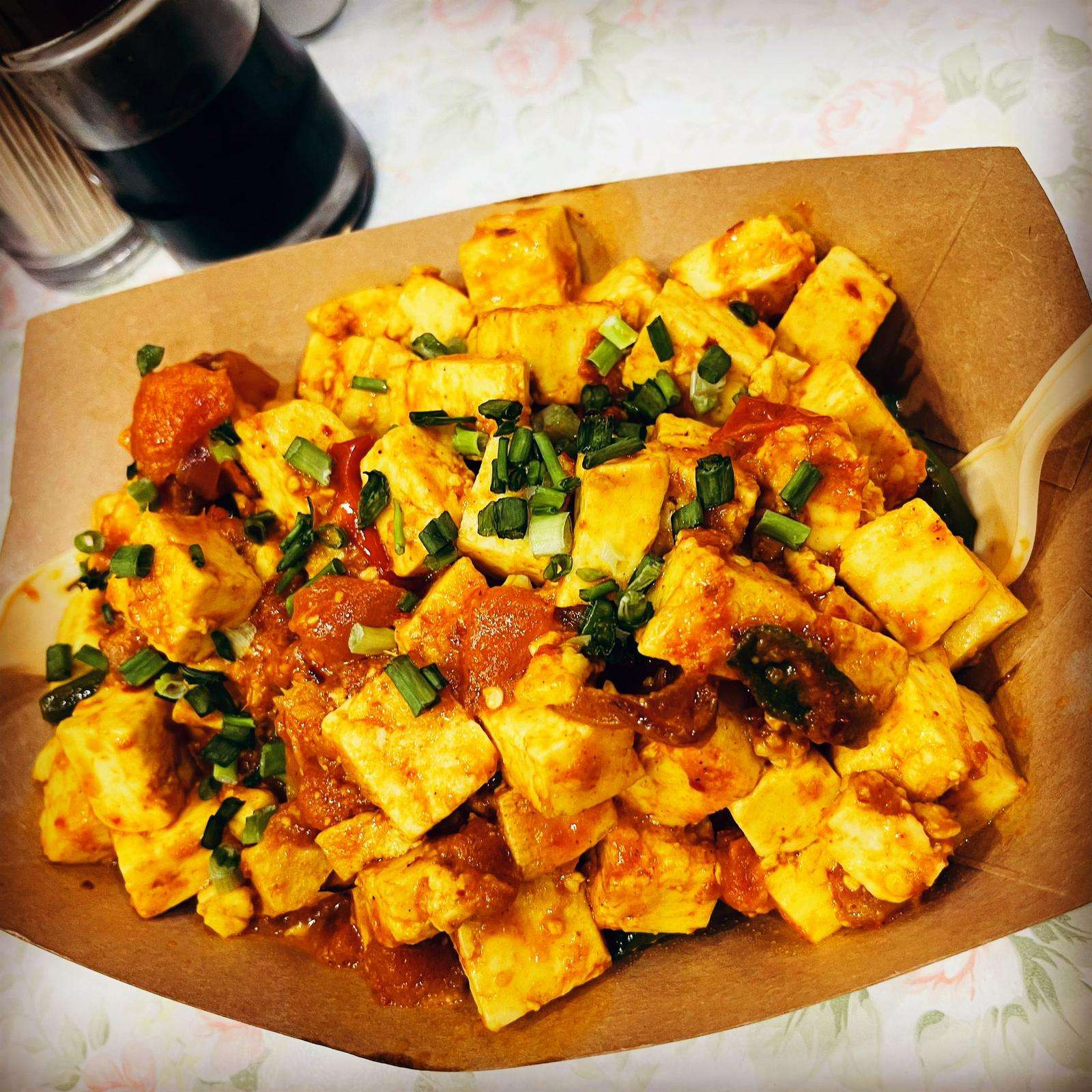 Spicy Paneer served on a white plate against a white background.
