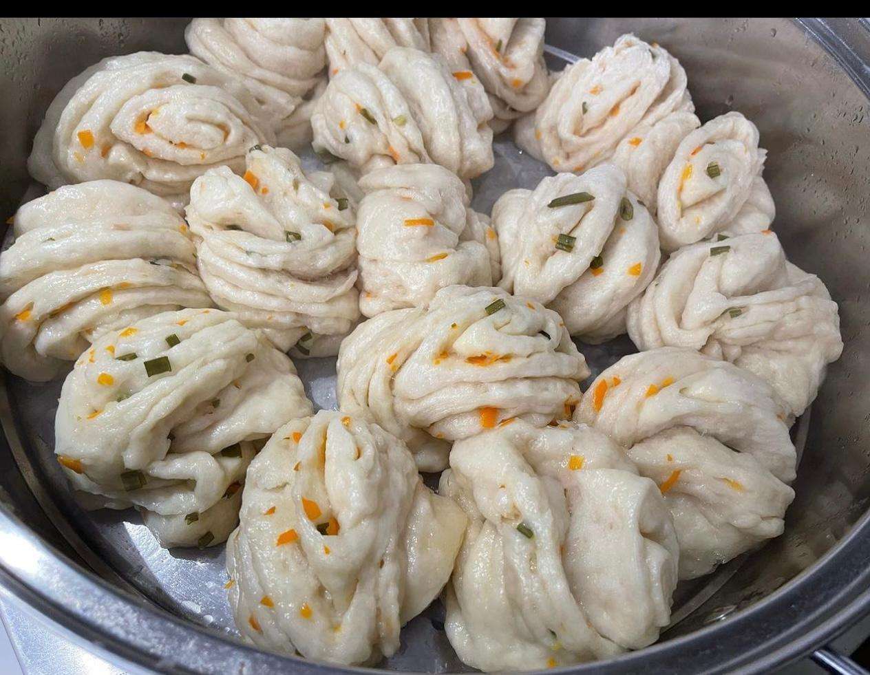 Tibetan Tingmo Buns freshly cooked on a metal bowl in the kitchen.